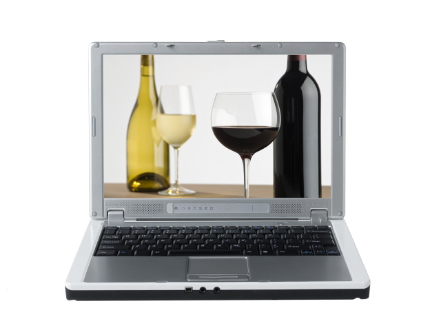 Laptop with screenshot showing 2 bottles of wine and white and red wine in glasses.