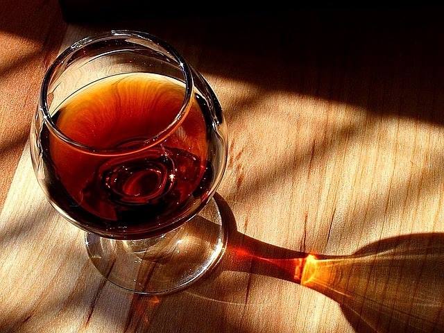 Closeup of a glass of port wine resting on a table